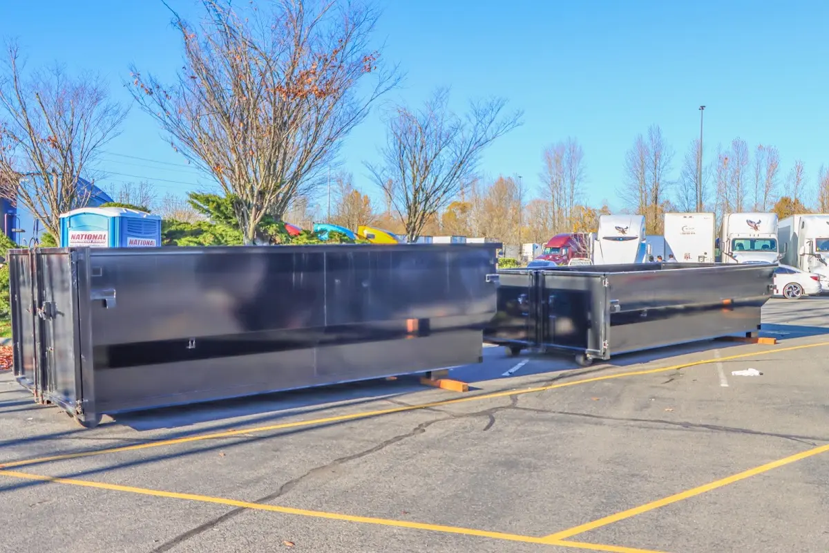 Professional dumpster rental service with roll-off container on residential driveway in Pound Ridge